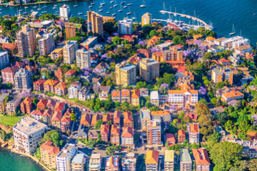 The many colourful apartments in Northern Sydney scattered over the land between the ocean areas,