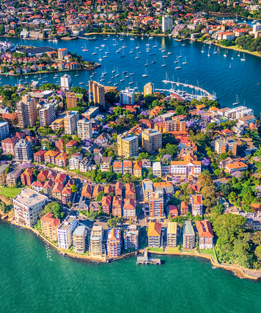 The many colourful apartments in Northern Sydney scattered over the land between the ocean areas,